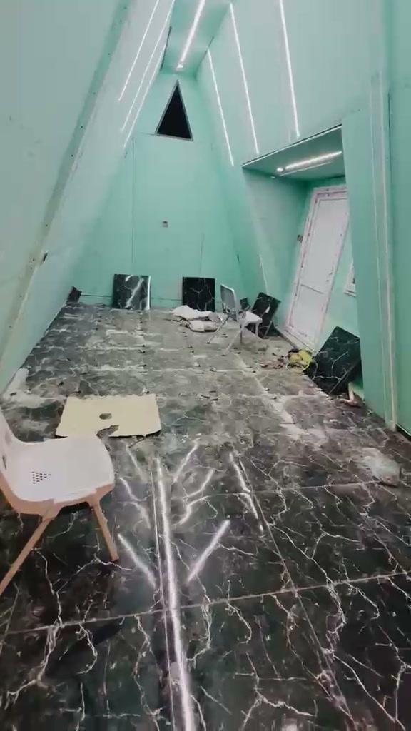 Double-height A-frame interior volume with marble-look floor